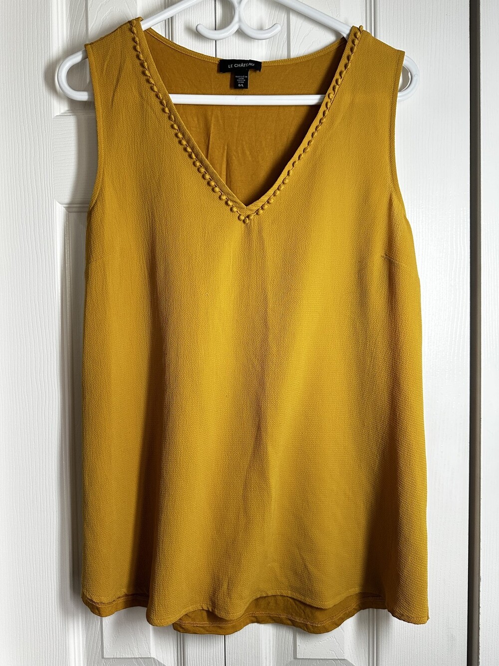 Le ChΓ’teau Mustard Yellow Sleeveless Blouse with Pom-Pom V-Neck Detail #108
